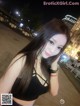 A woman in a black top posing for a picture.