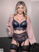 A woman in a black lingerie posing for a picture.